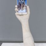 Ira Lombardia. Swipe, Tap, Pinch(Venus). 2019. Marble and single channel video (2´33”) played on Iphone6. 14.5 x11x7cm + Pedestal 24,5 x 2,5 cm.